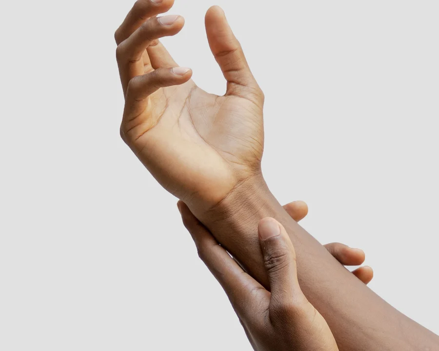 A hand holding the wrist of the other arm